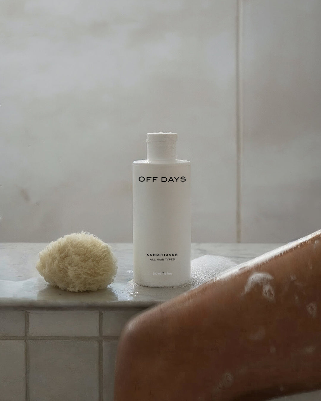 Woman applying OFF DAYS conditioner — does conditioner cause hair fall explained